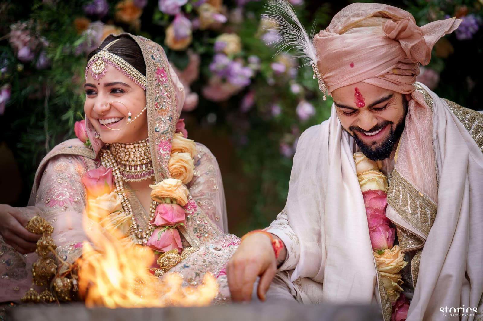 Anushka and Virat laughing beside the sacred fire at their wedding