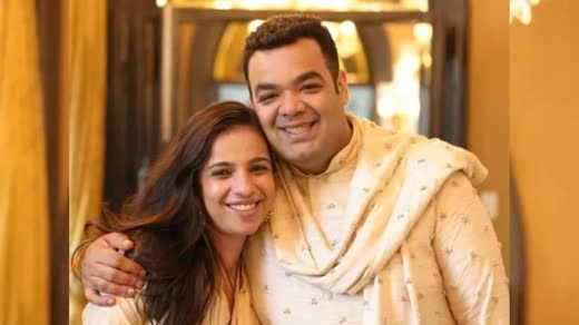 Tina Tharwani and Saurabh Malhotra smiling together at a wedding
